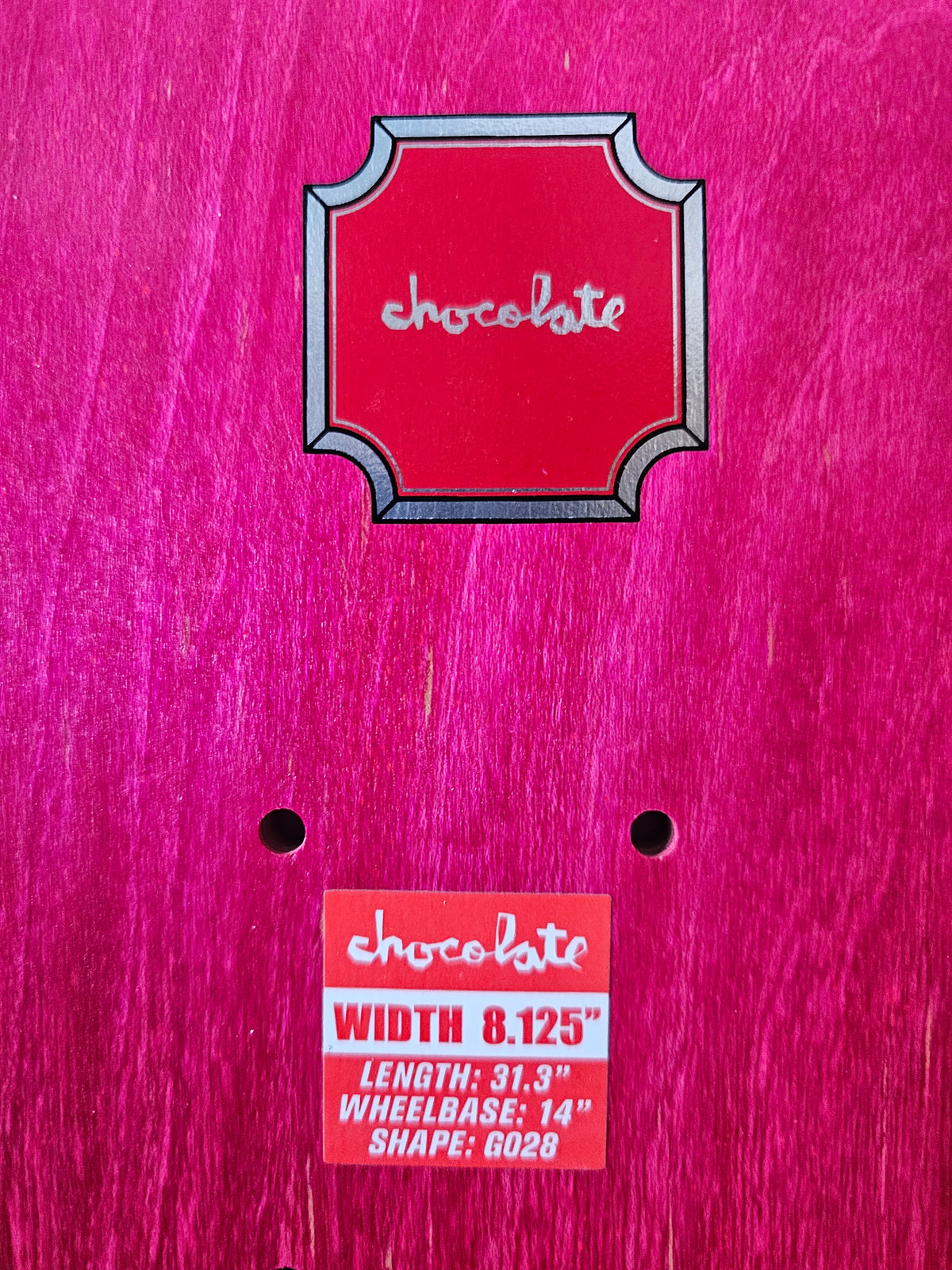 Full pink-stained woodgrain top of Chocolate Marc Johnson deck