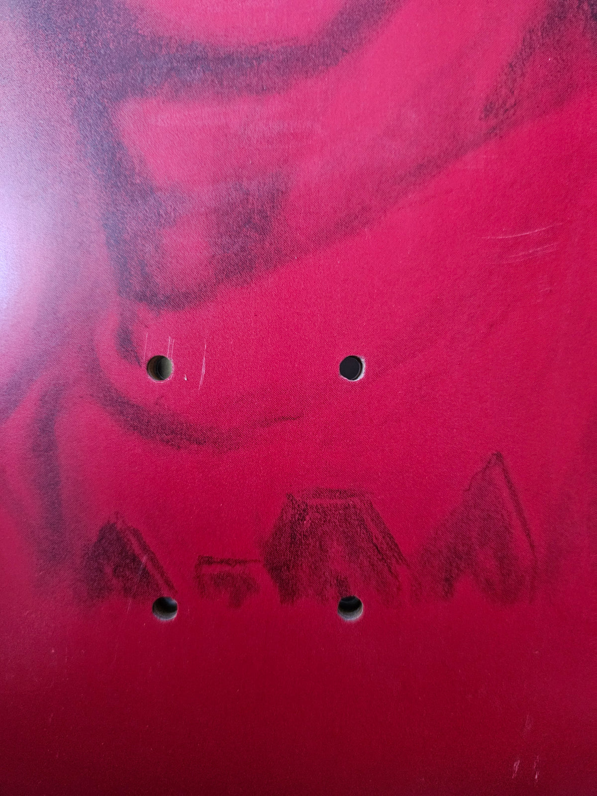 Lower truck-mount holes and scratches on red graphic