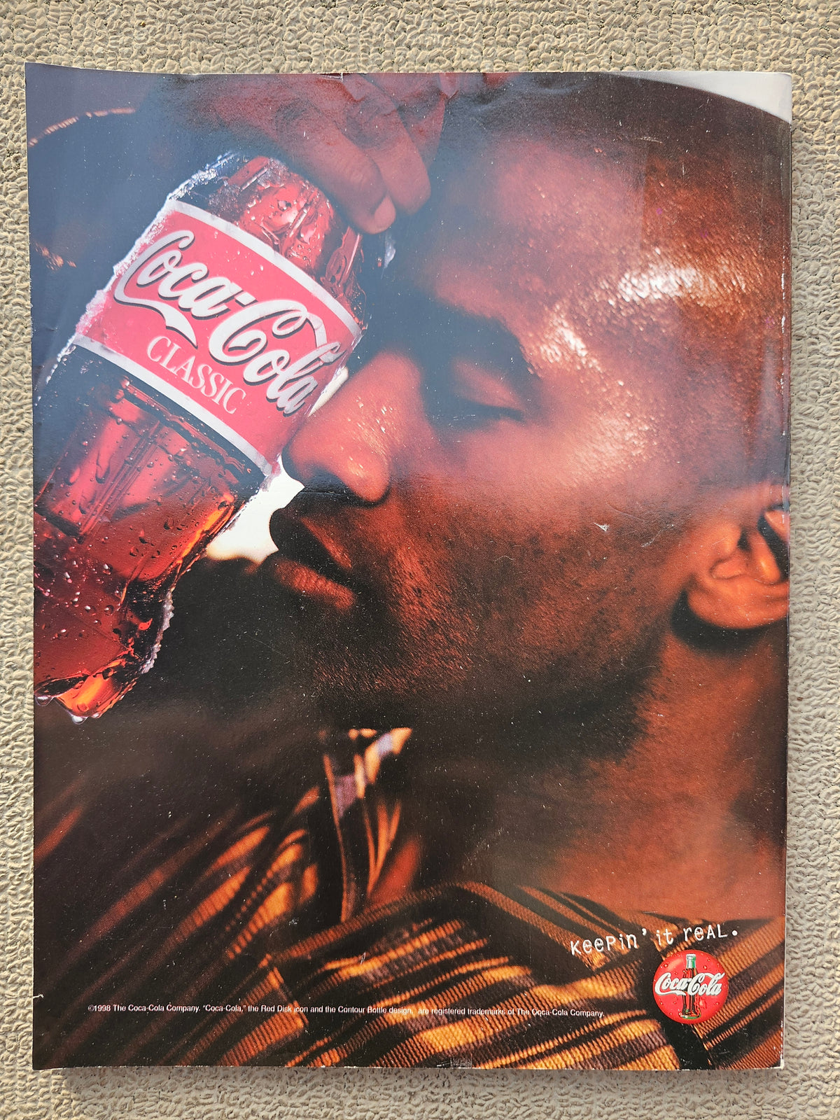 Coca-Cola Classic advertisement on back cover showing wear
