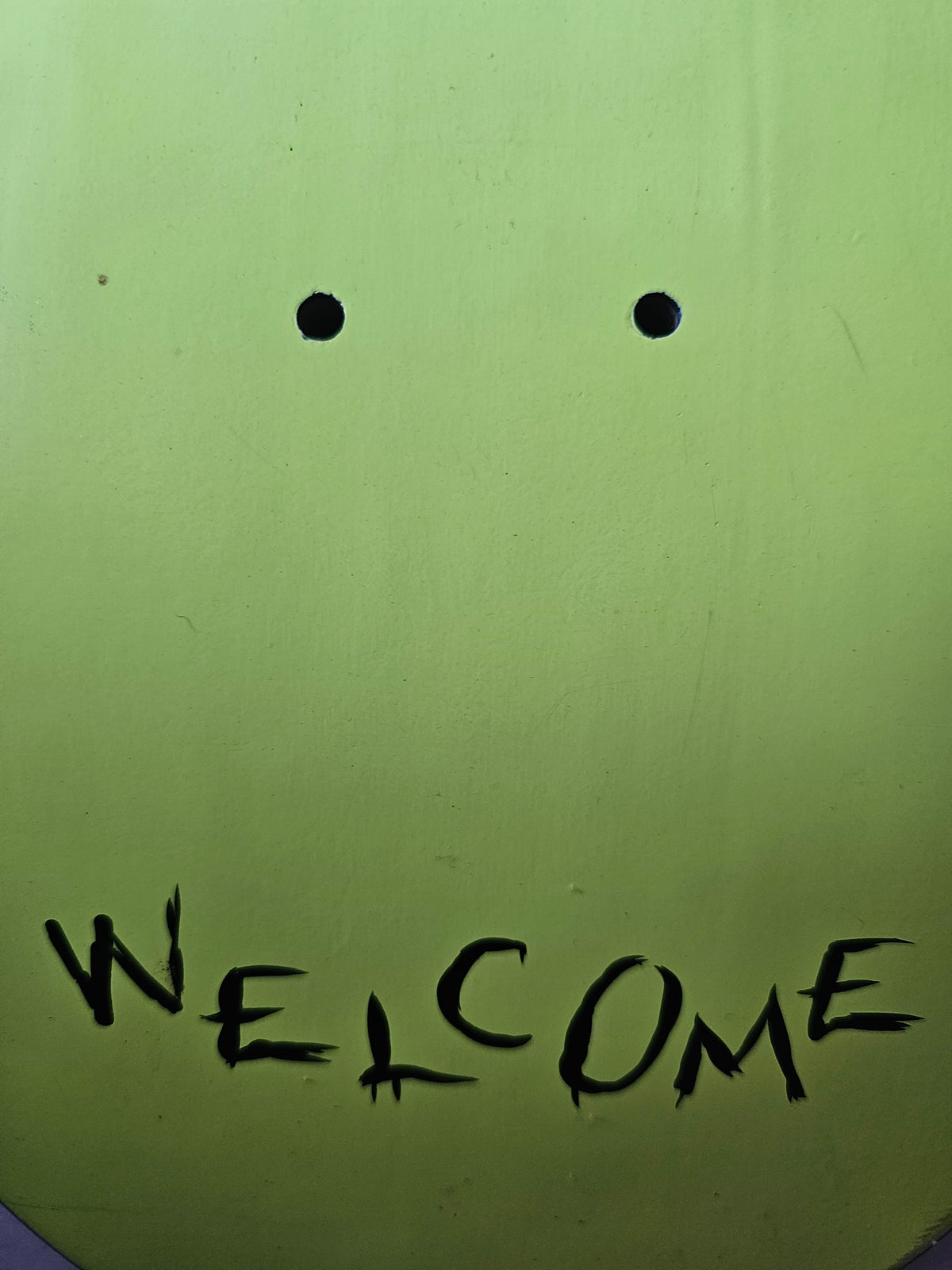 Welcome lettering and cosmetic marks near tail truck-mount holes